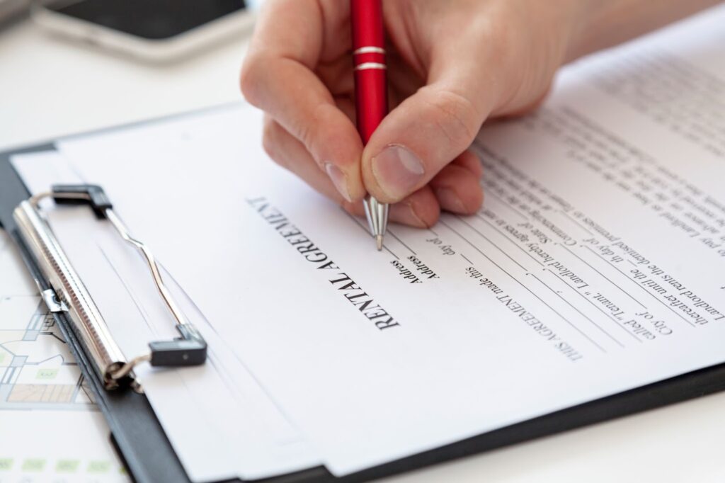 Man signing a contract for a new house