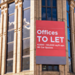 office building with a banner Offices to let