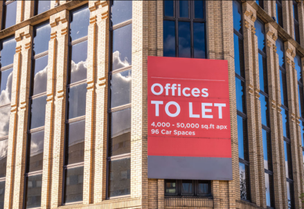 office building with a banner Offices to let