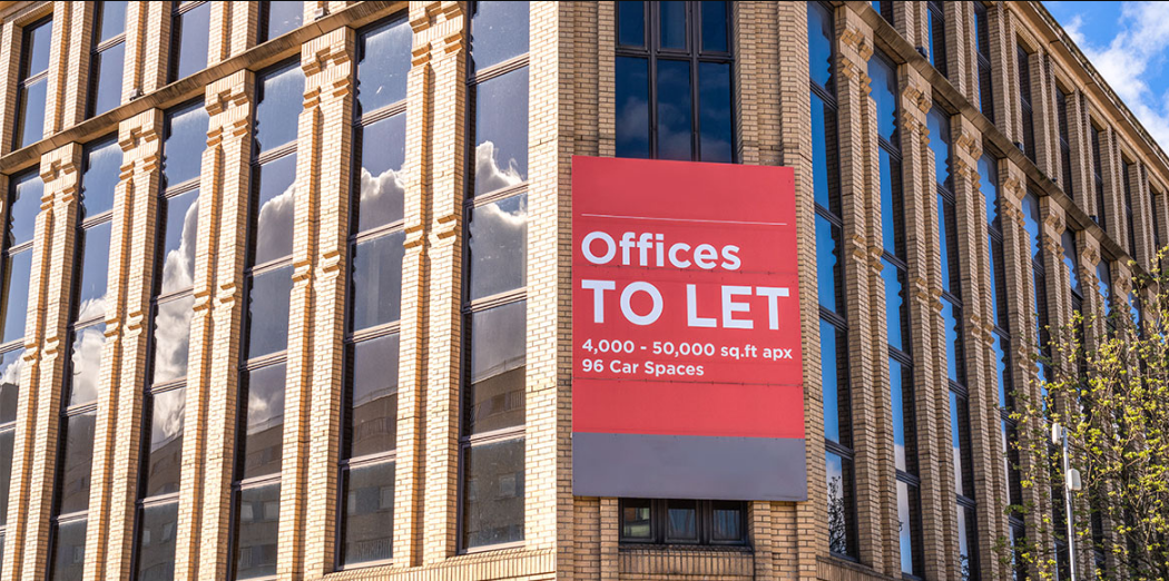 office building with a banner Offices to let