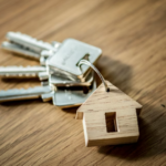 small wooden house and a bunch of keys on wooden table