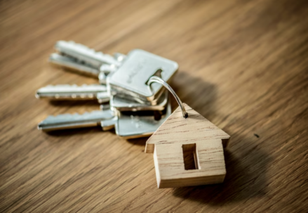 small wooden house and a bunch of keys on wooden table