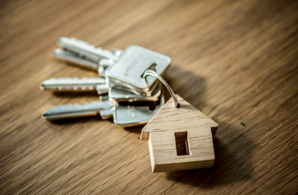 small wooden house and a bunch of keys on wooden table