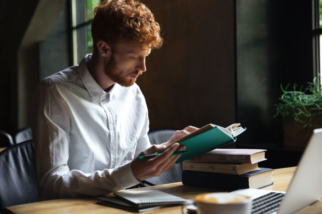 A man is reading a book with concentration