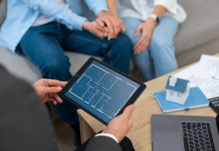 Real estate agent showing house to potential buying couple