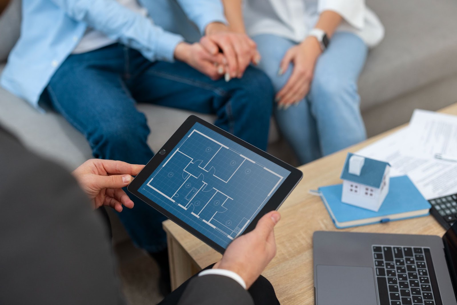 Real estate agent showing house to potential buying couple