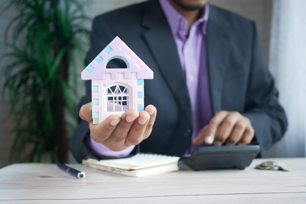 man holding a house in his hands