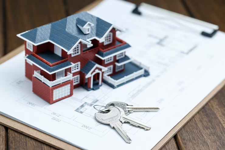 House model, Key and Plan on Wooden Desktop